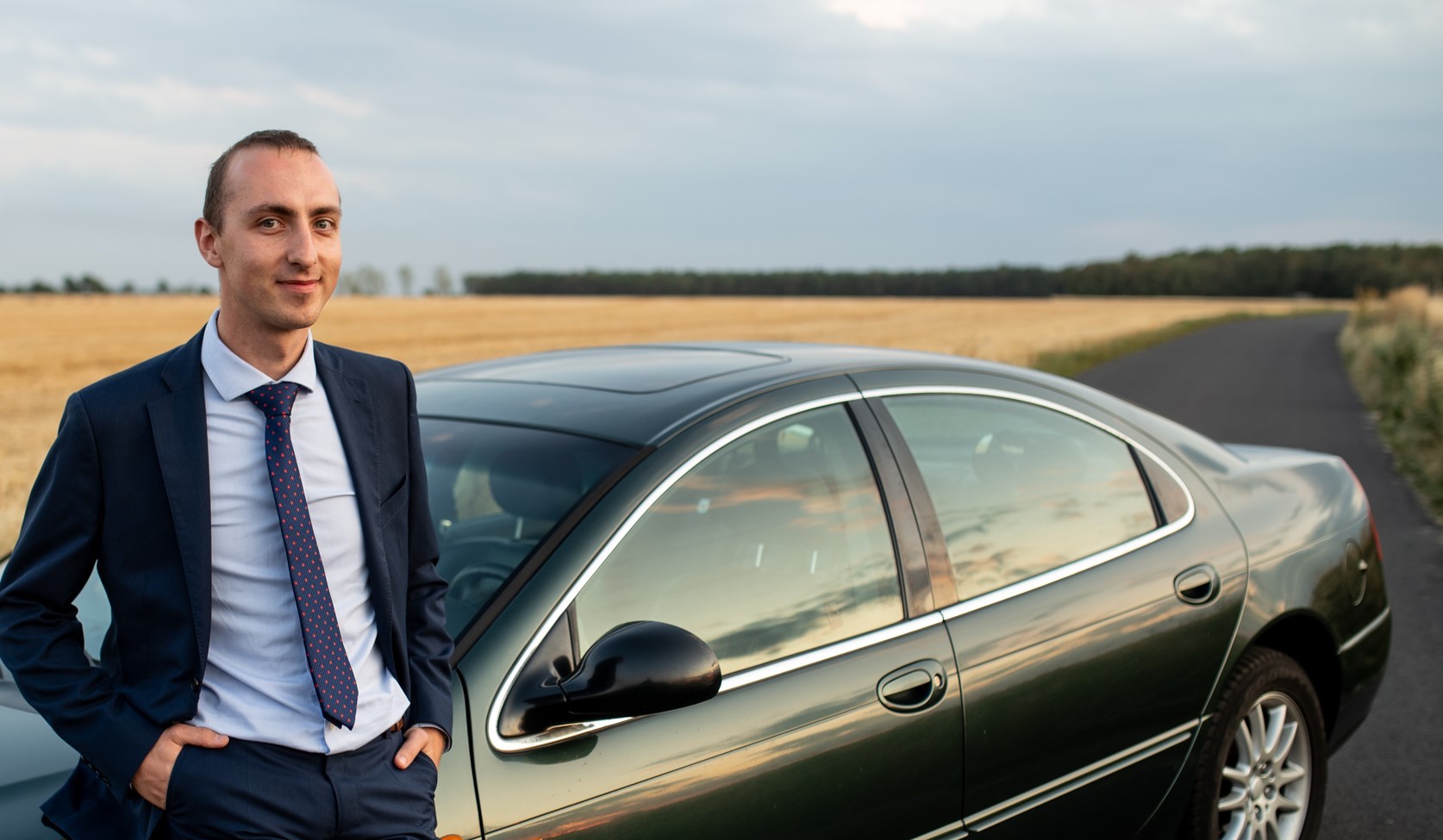 Me in front of my car on the road between the crop fields